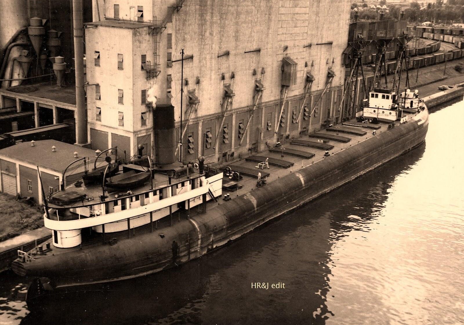 black and white image with whaleback docked at the elevator