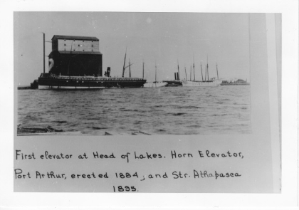 older image with text below that reads "First elevator at Head of Lakes. Horn Elevator, Port Arthur, erected 1884, and Str. Athapasea 1855"