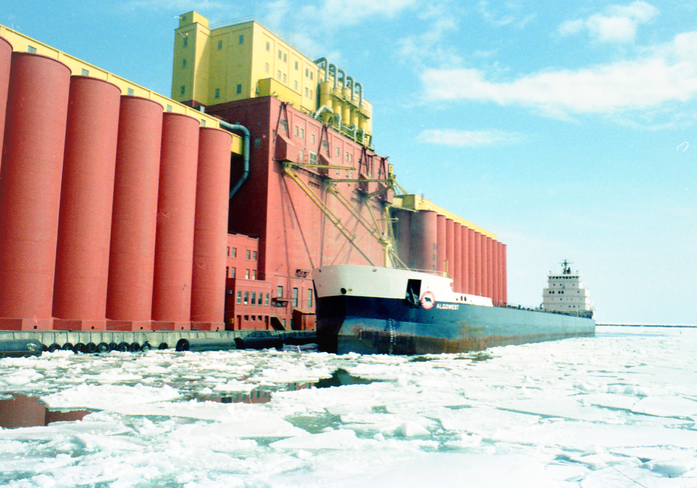 red elevator with ship docked and snow covering the frozen lake