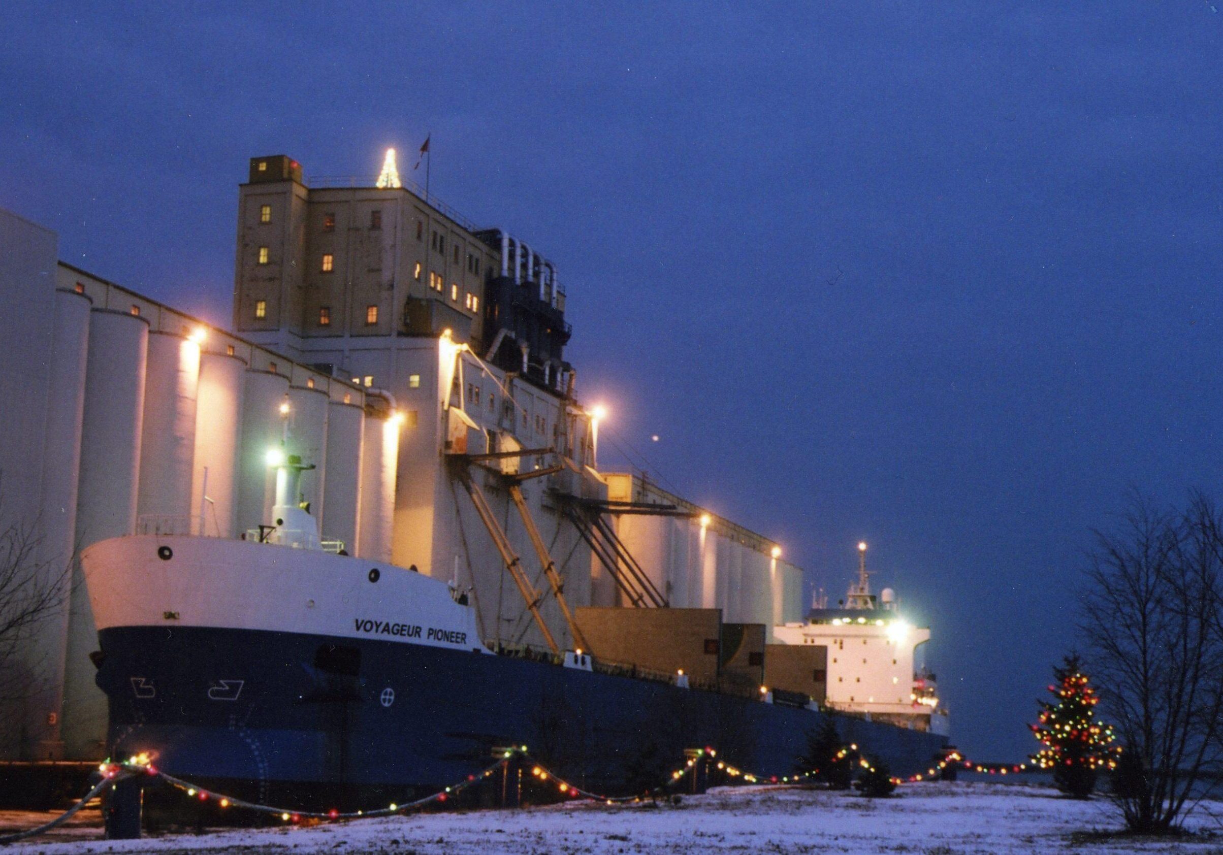 elevator with boat docked at night - lights glowing