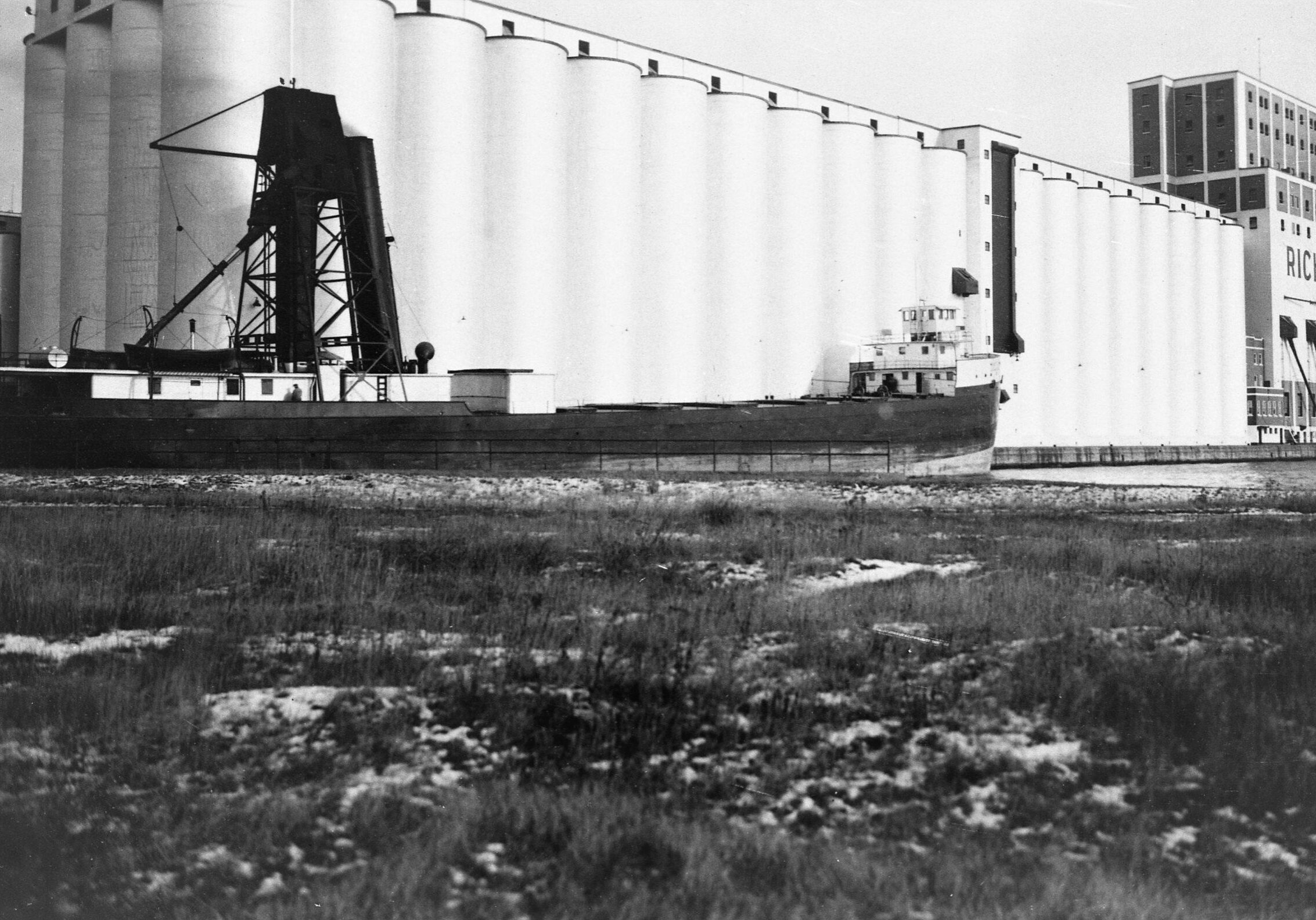 black and white image of water in lower portion and the elevator in the top third