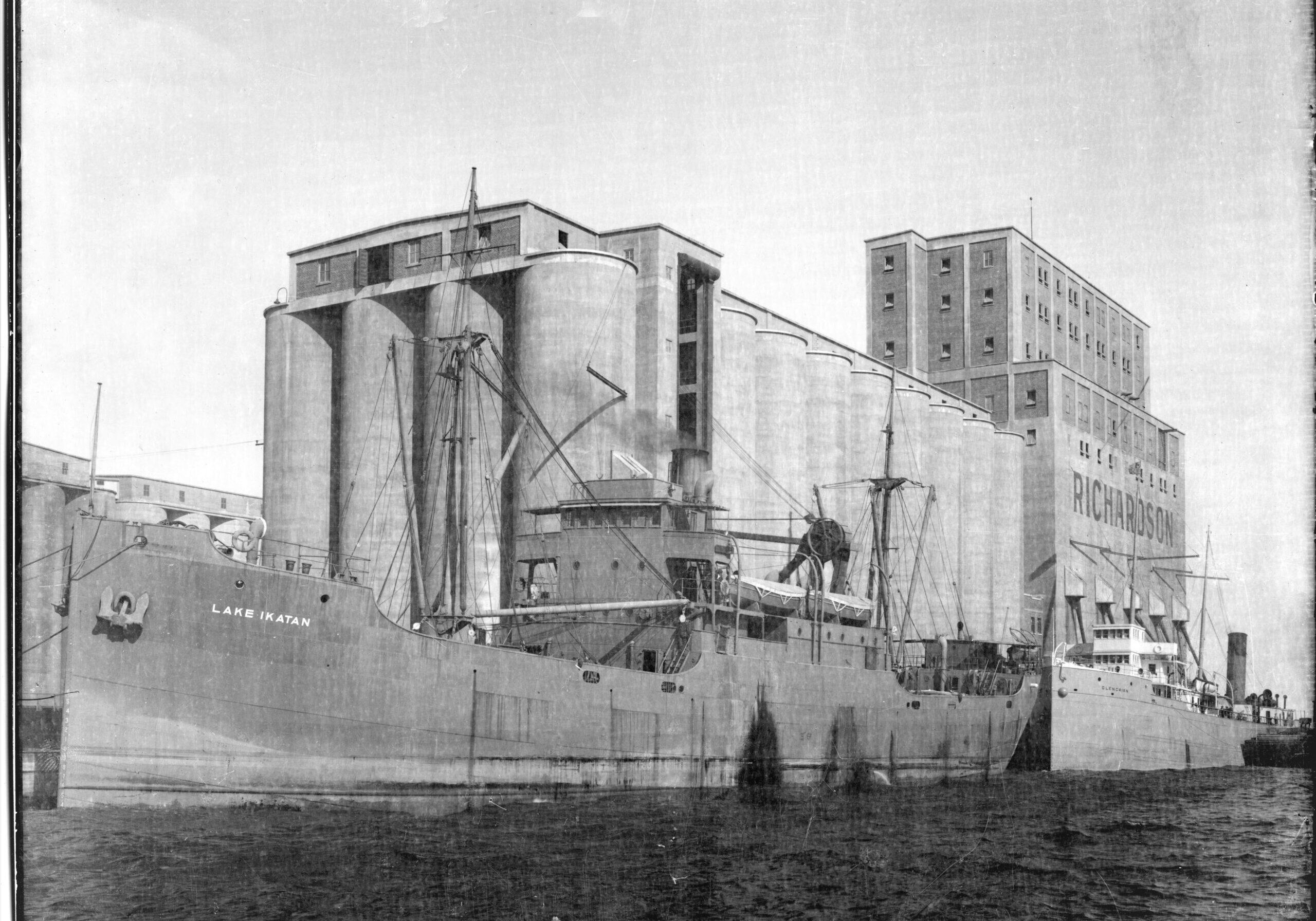 black and white image of elevator with ship docked